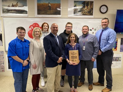 Image of Culver receiving award with students